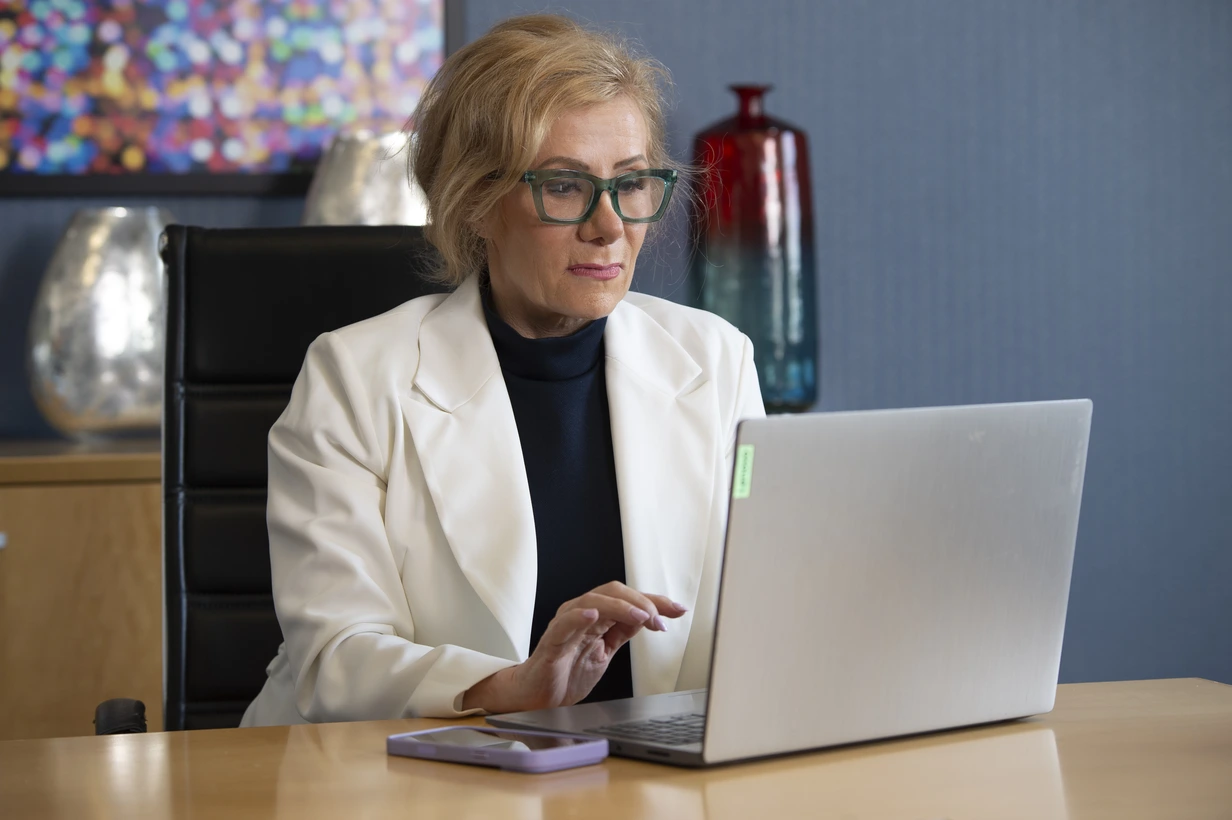 Dee DeRidder working at her laptop